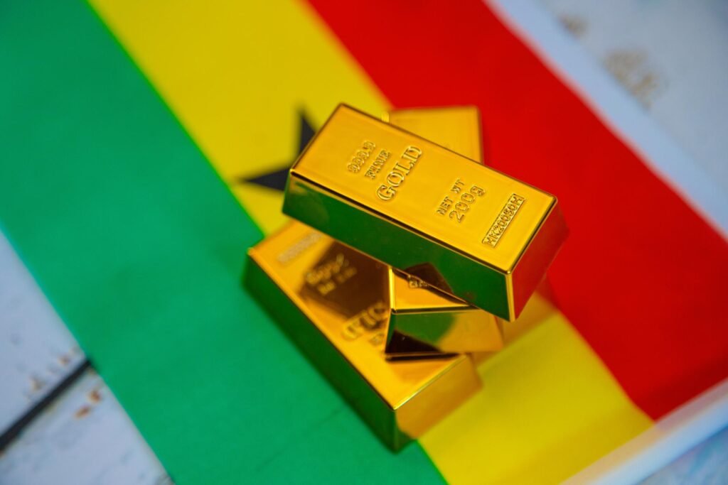 Editorial illustration of Ghana’s gold industry showing mining activity, gold prices, and investor concerns over new tax reforms.